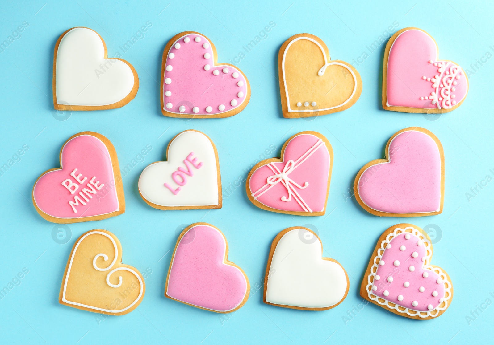 Photo of Decorated heart shaped cookies on color background, top view. Valentine's day treat