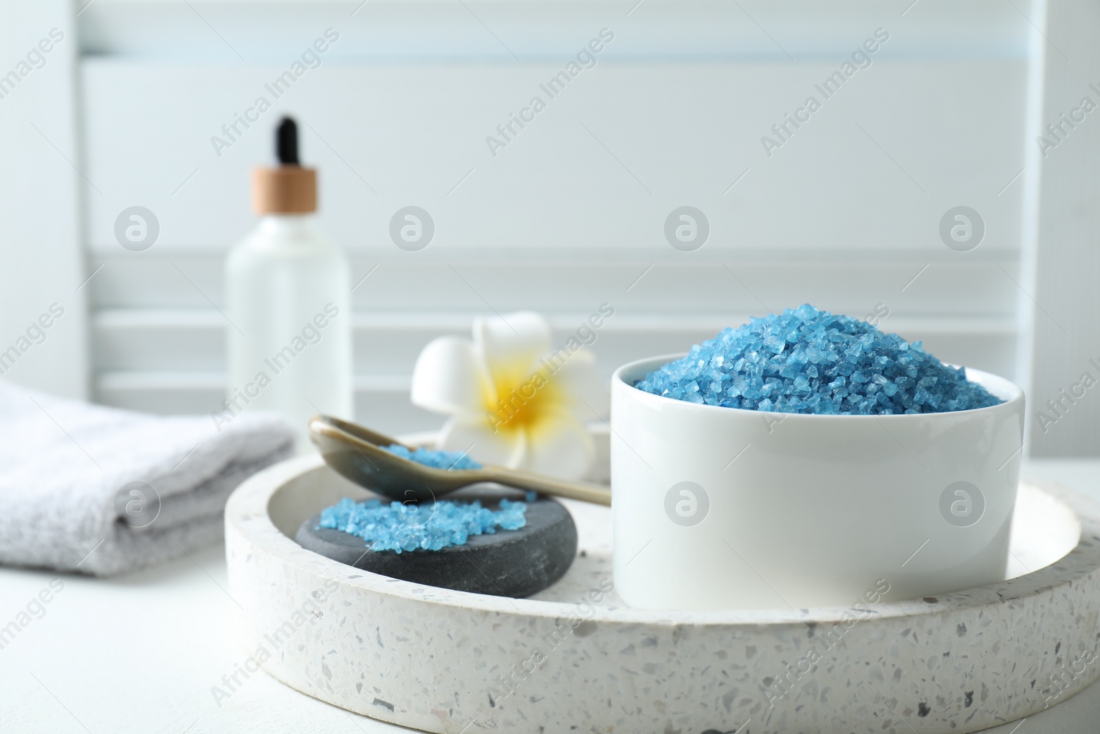 Photo of Composition with blue sea salt on white table indoors, closeup