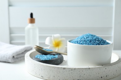 Composition with blue sea salt on white table indoors, closeup