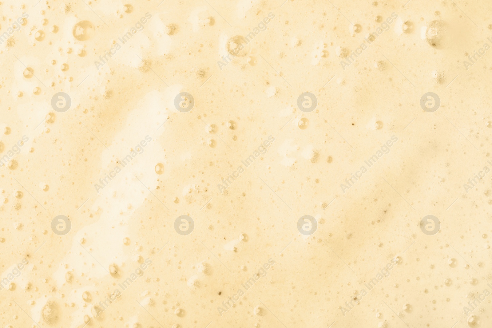 Photo of Tasty smoothie with bubbles as background, closeup