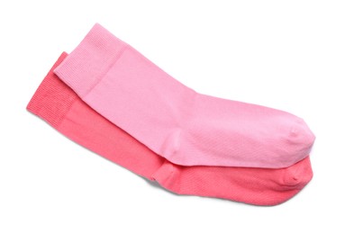 Different pink socks on white background, top view