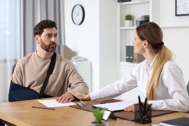 Photo of Injured woman having meeting with lawyer in office