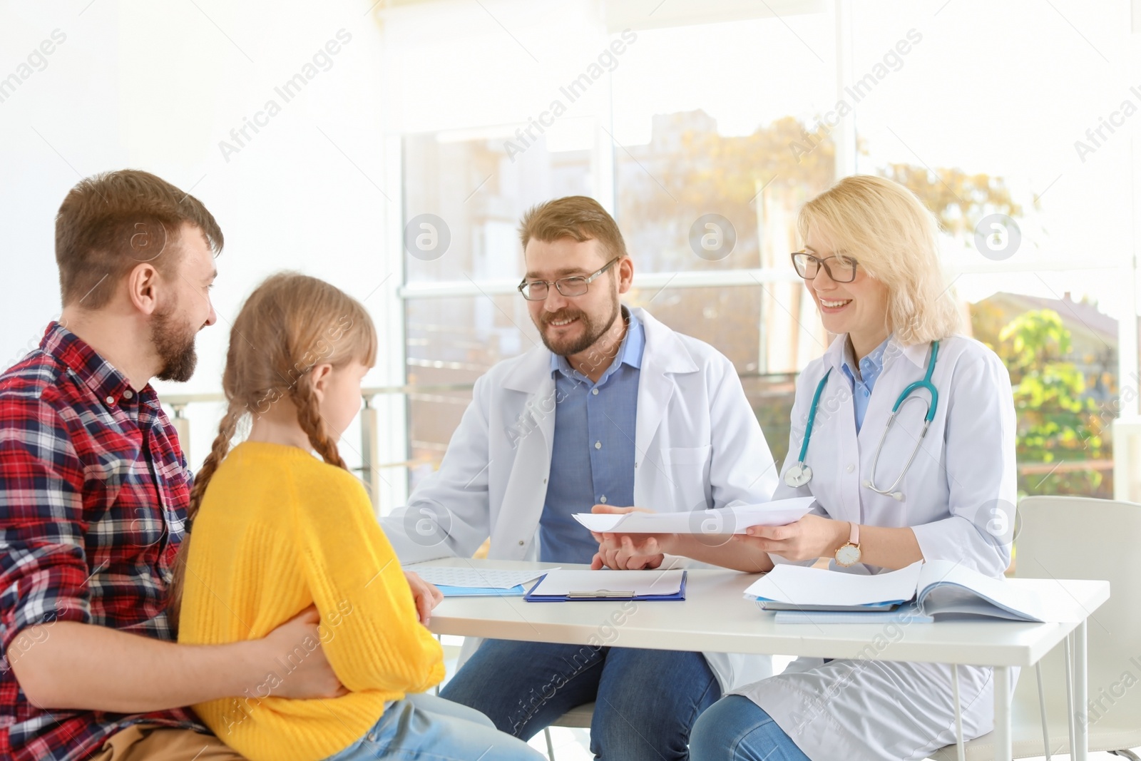 Photo of Little girl with father visiting children's doctors in hospital