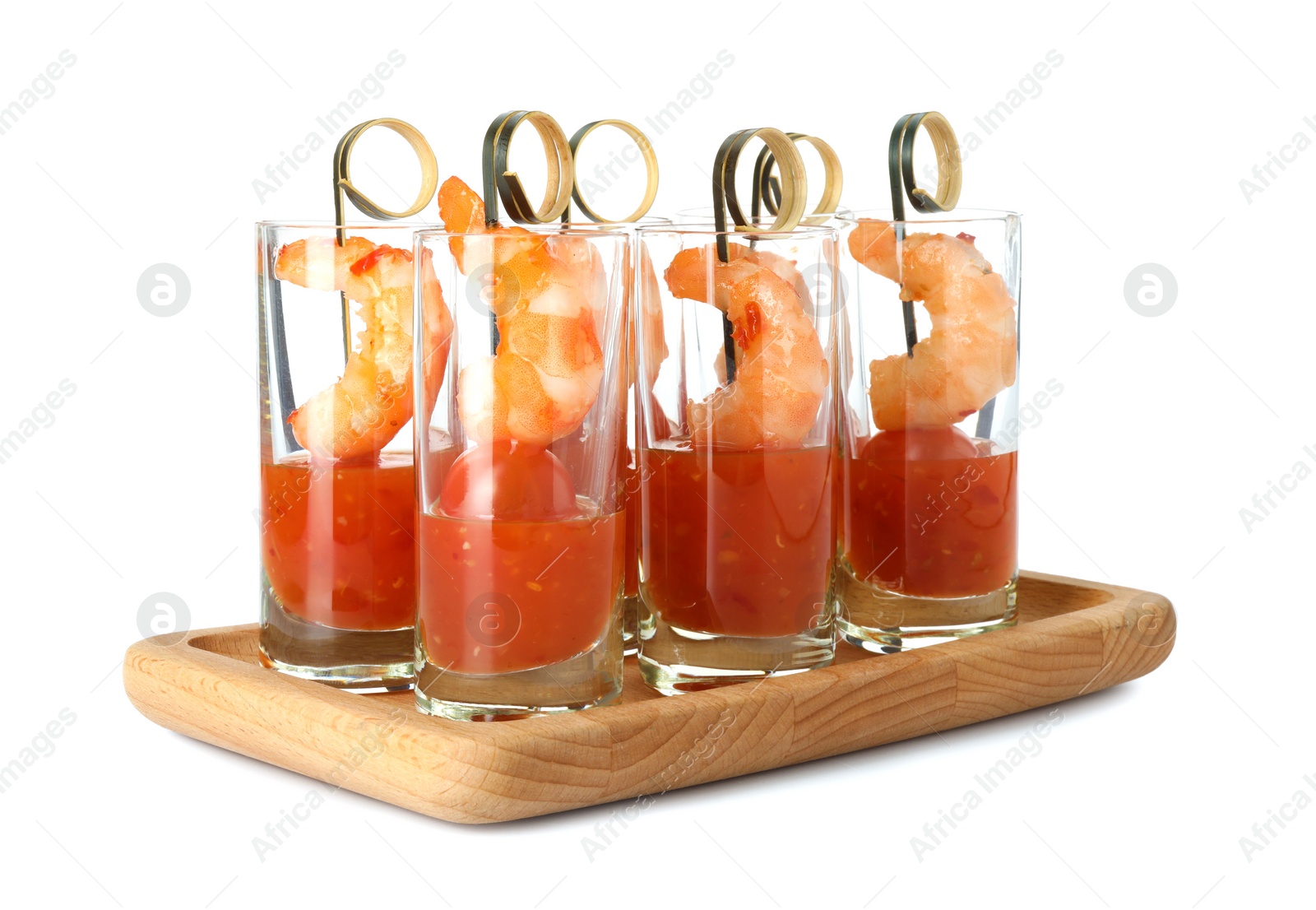 Photo of Tasty canapes with shrimps, tomatoes and sauce in shot glasses isolated on white