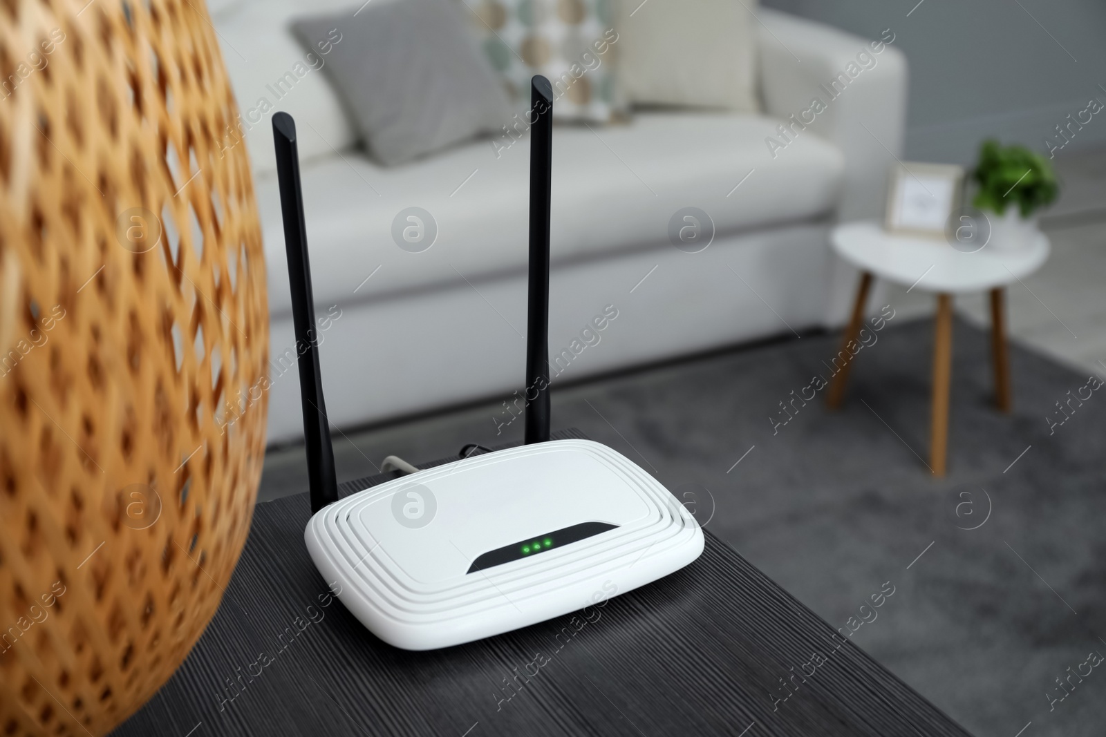 Photo of Wi-Fi router on black wooden table in room