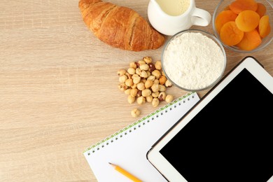 Photo of Glycemic index concept. Flat lay composition with different products and tablet on wooden table, space for text