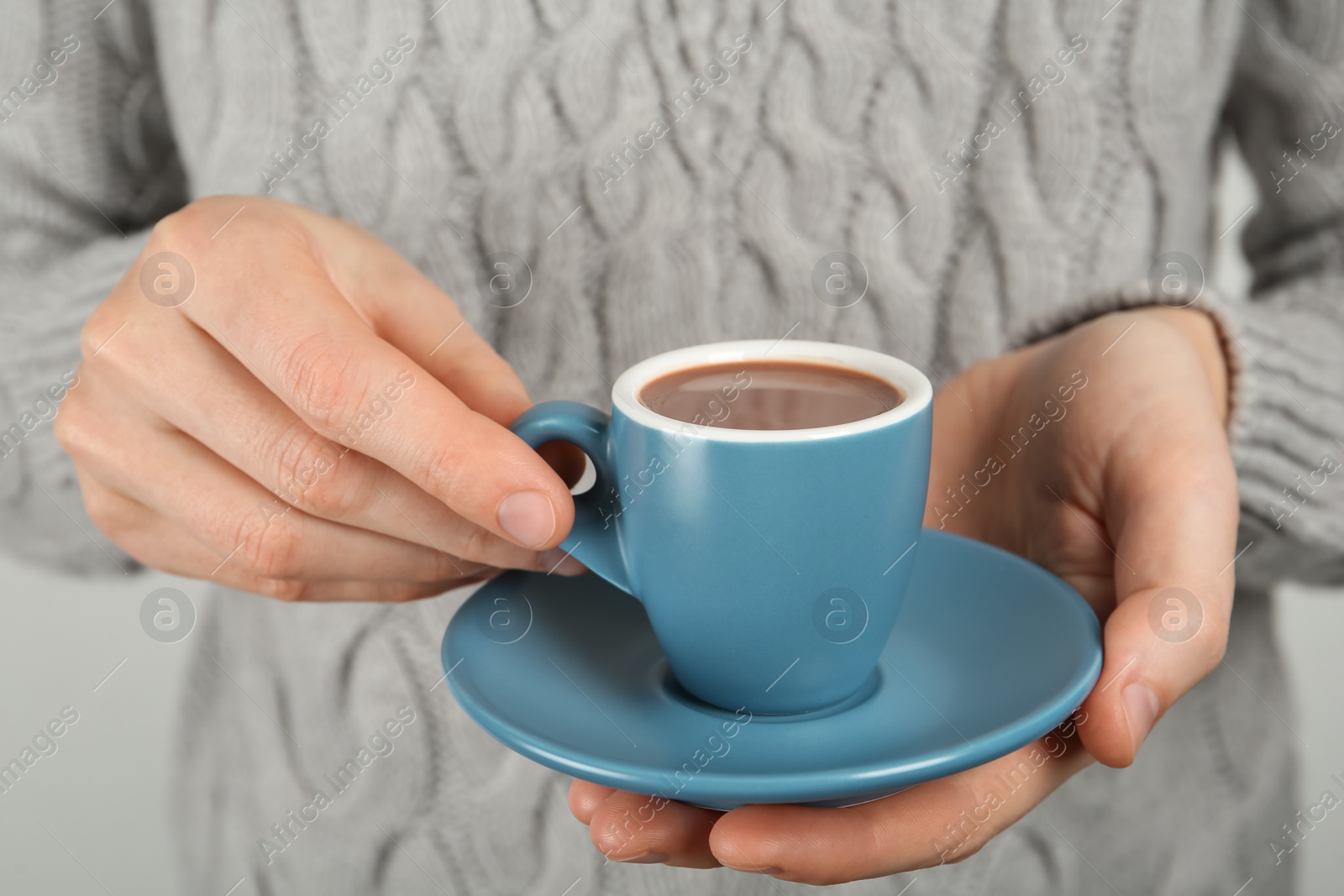 Photo of Woman holding cup of delicious hot chocolate, closeup