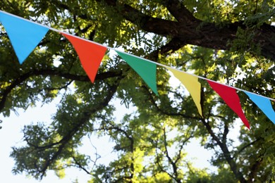 Colorful bunting flags in park. Party decor