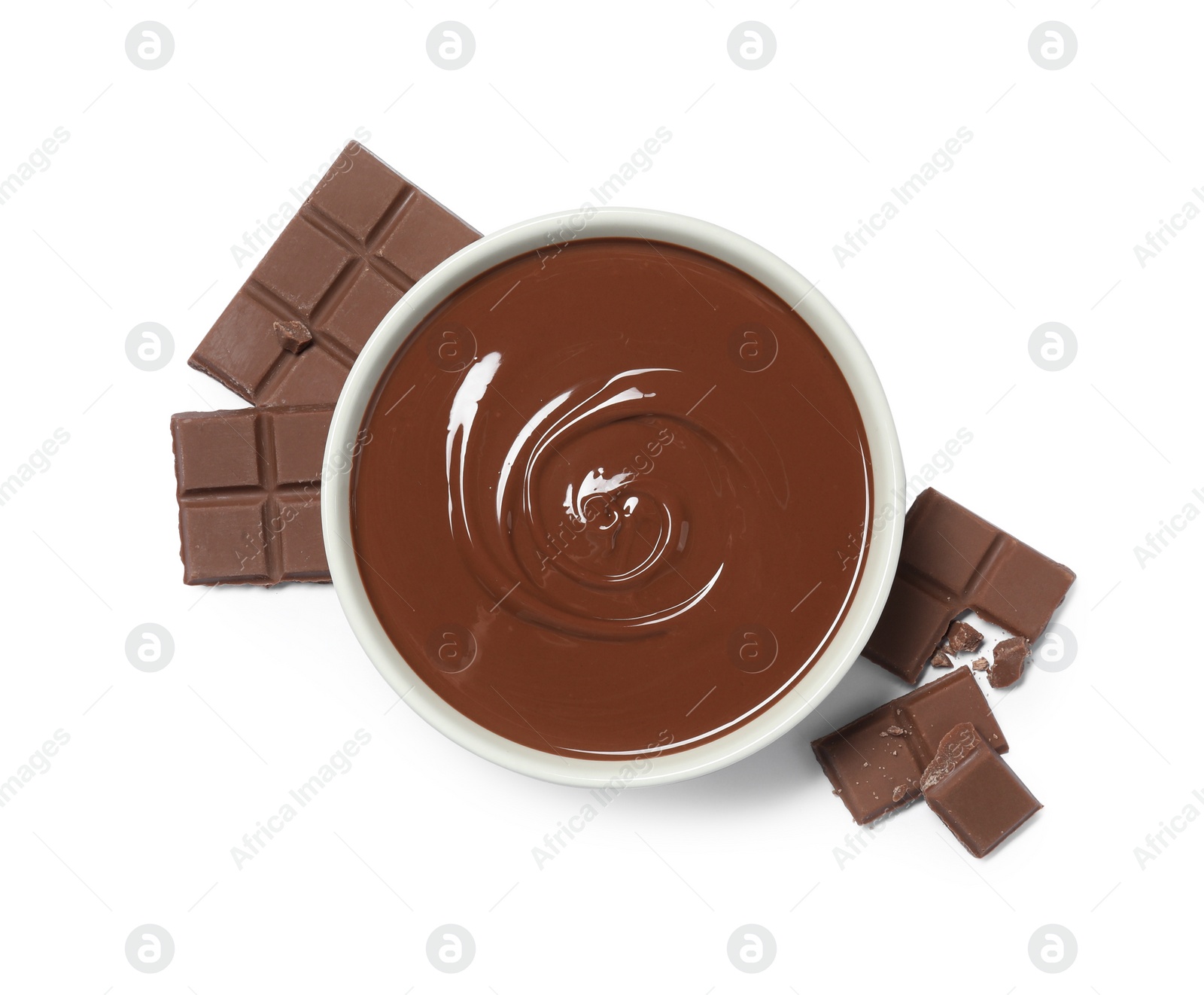 Photo of Milk chocolate paste in bowl and pieces isolated on white, top view