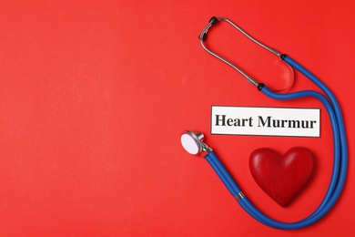 Photo of Flat lay composition with stethoscope and wooden heart on color background. Space for text