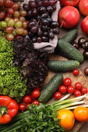 Different fresh ripe vegetables and fruits on wooden table, flat lay