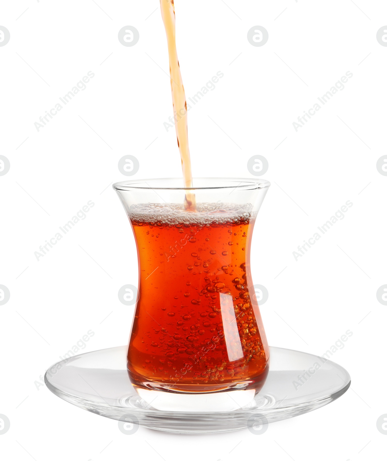 Photo of Pouring traditional Turkish tea into glass on white background