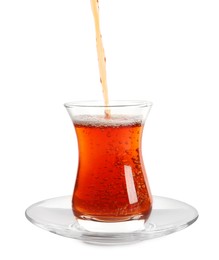 Pouring traditional Turkish tea into glass on white background