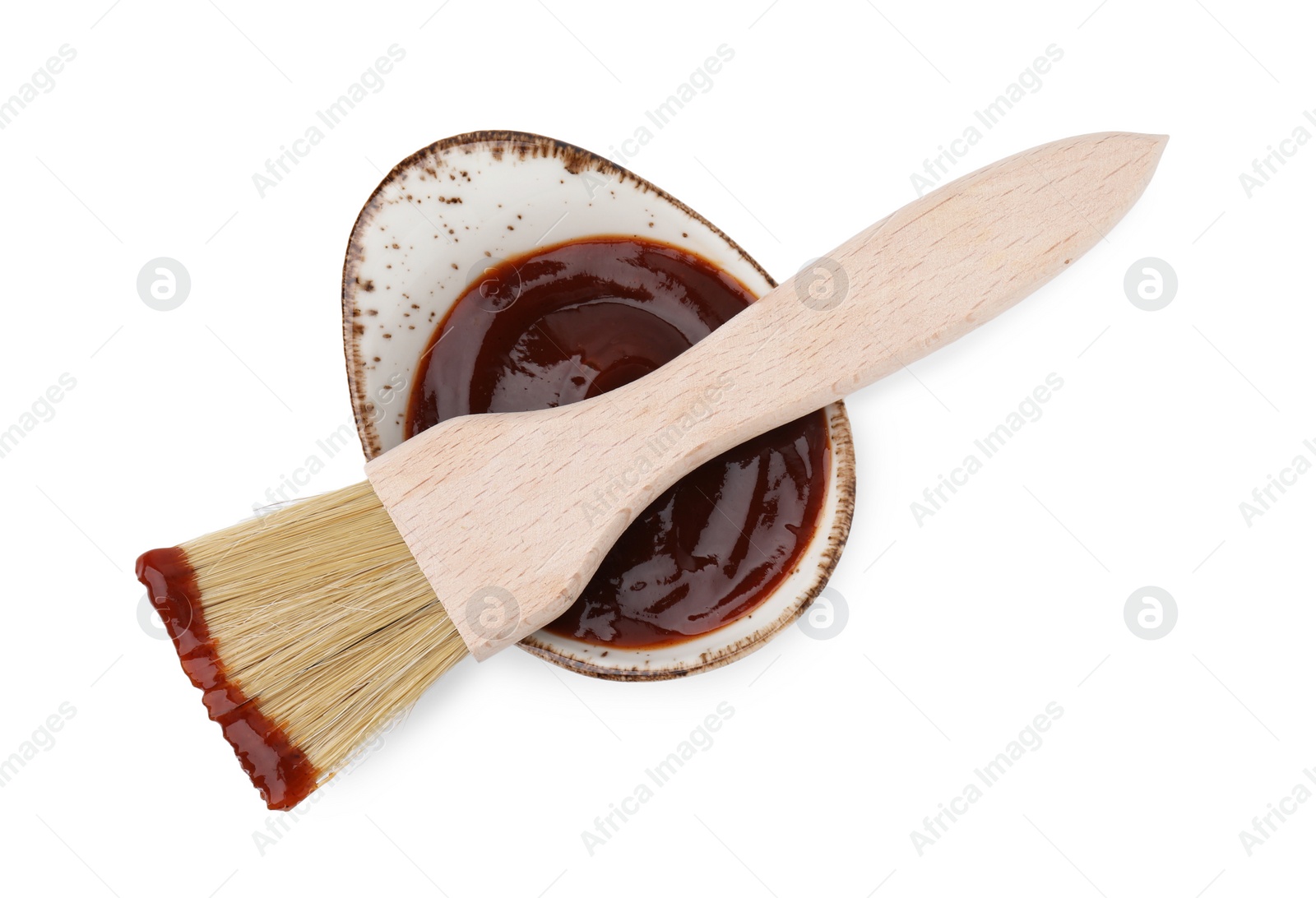 Photo of Marinade in gravy boat and basting brush isolated on white, top view