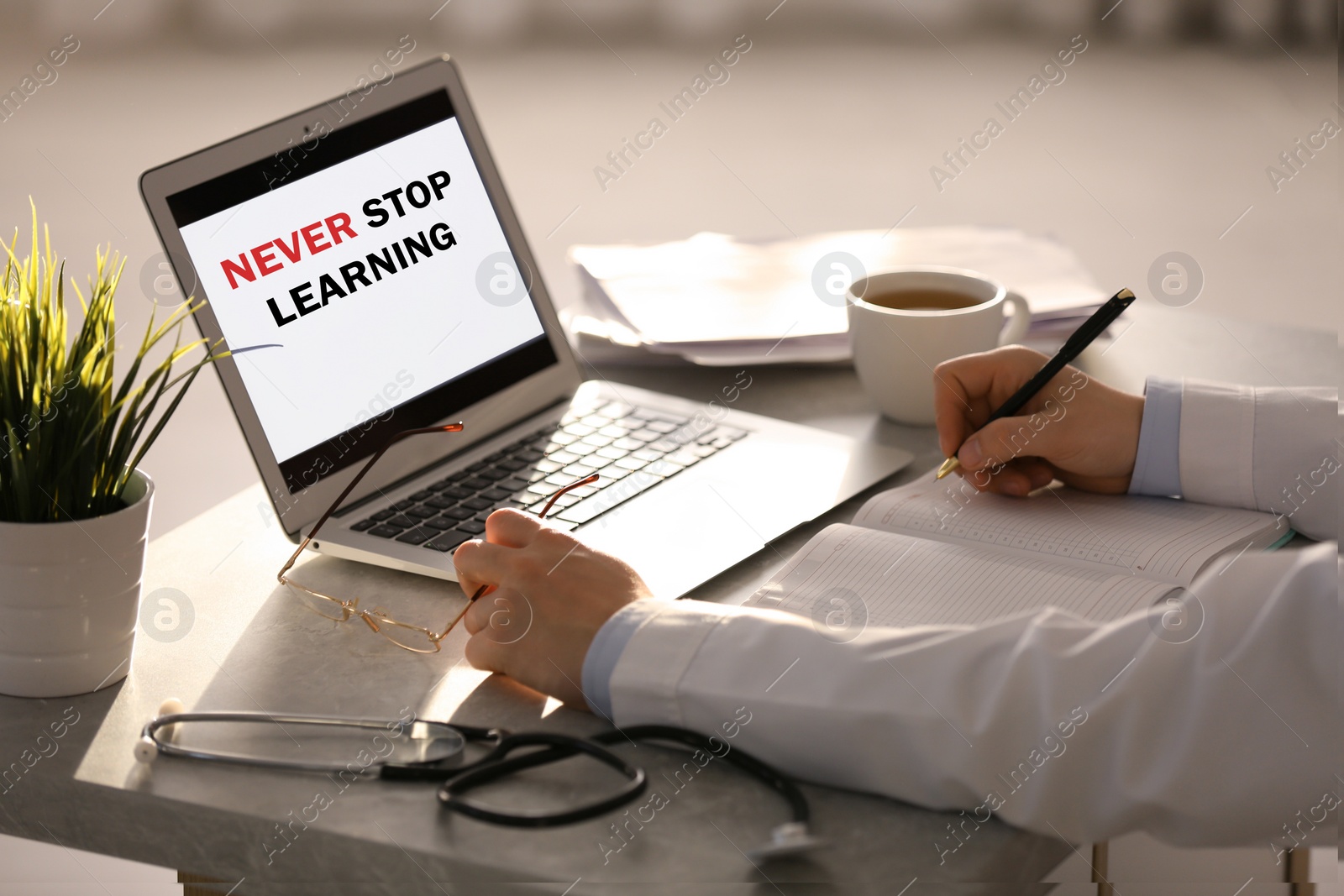 Image of Doctor working with laptop at table in office, closeup. Never stop learning