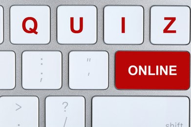 Image of Modern computer keyboard with text ONLINE QUIZ on buttons, top view