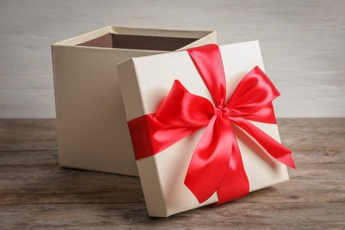 Open gift box on wooden table