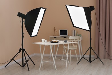 Photo of Professional equipment and composition with delicious dessert on white wooden table in studio. Food photography