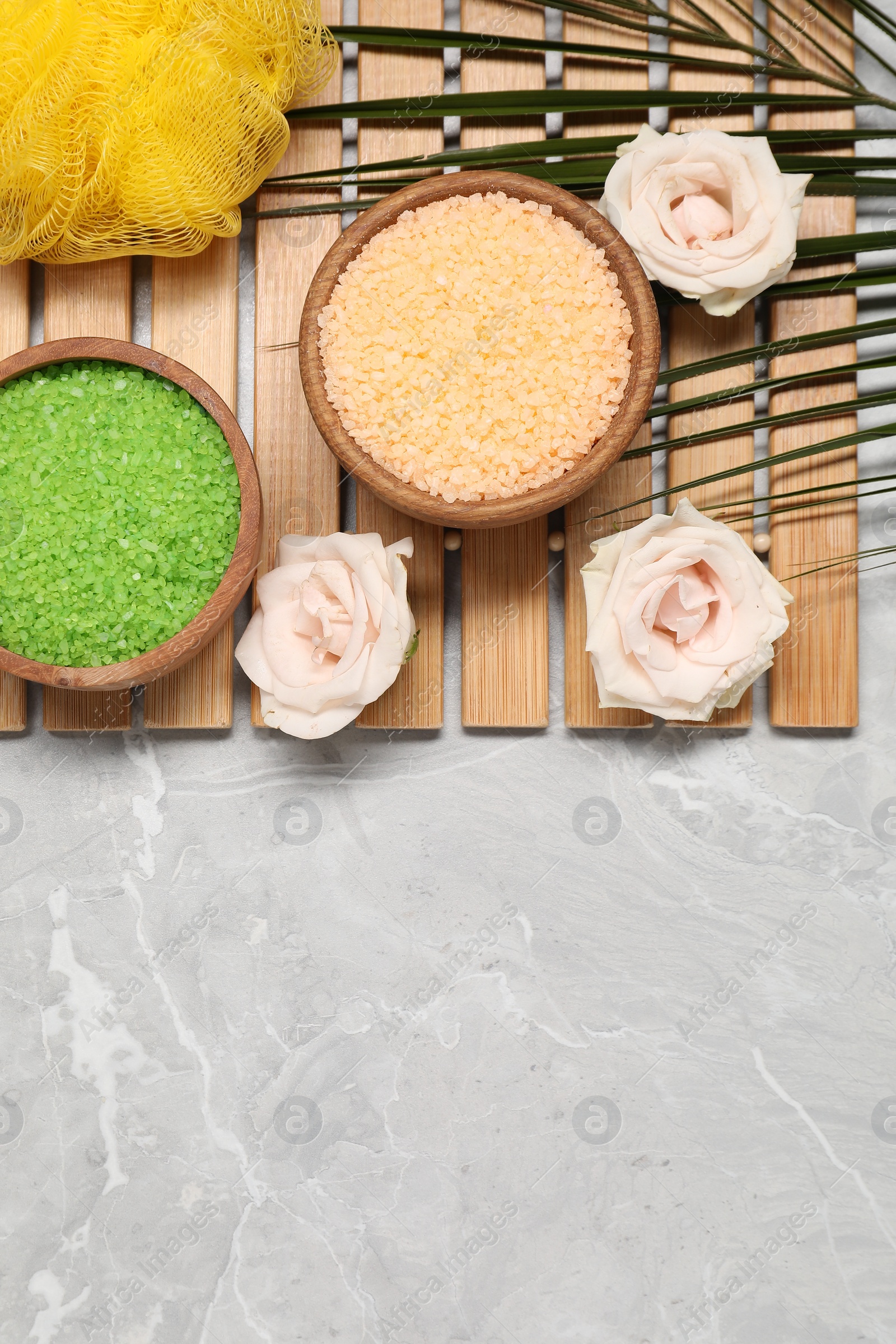 Photo of Flat lay composition with natural sea salt on grey marble table. Space for text