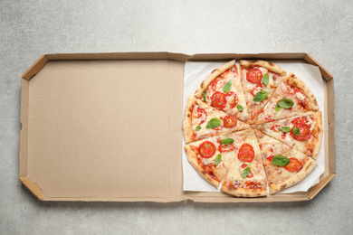 Delicious pizza Margherita in box on light grey table, top view
