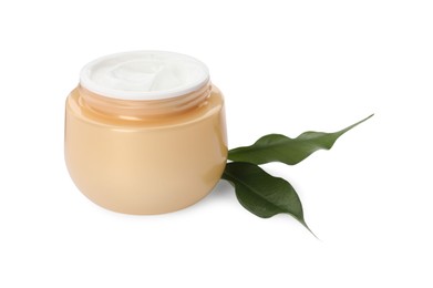 Photo of Face cream in jar and leaves on white background