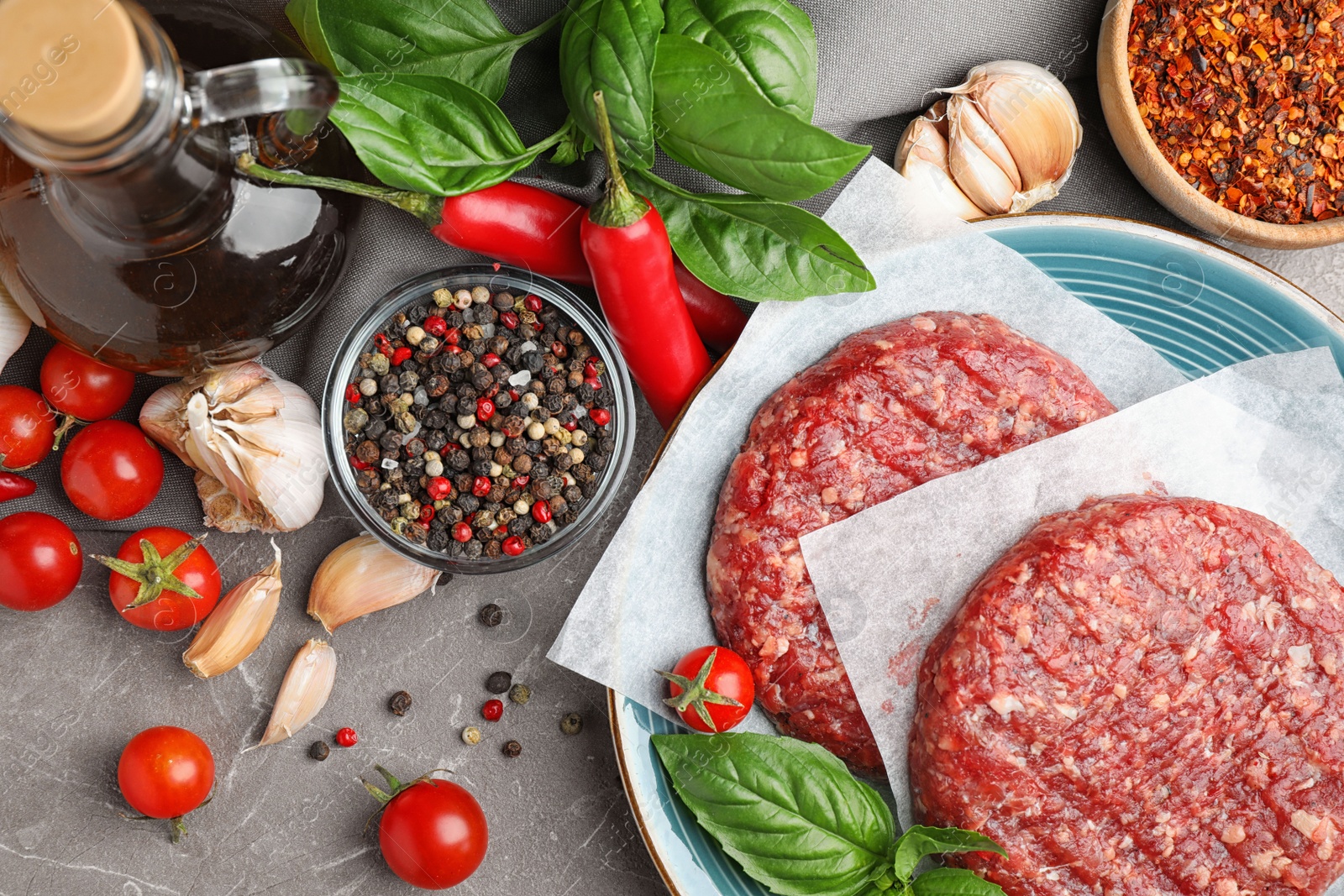 Photo of Flat lay composition with raw meat cutlets for burger on marble table