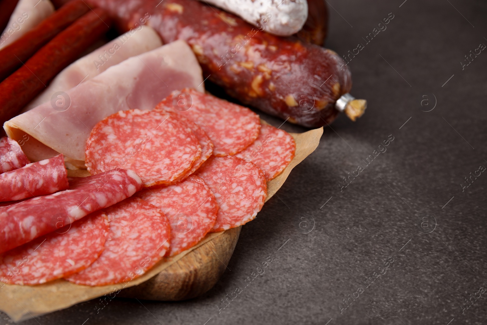 Photo of Different types of sausages on brown table, space for text