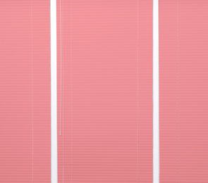 Image of Window with closed coral horizontal blinds as background