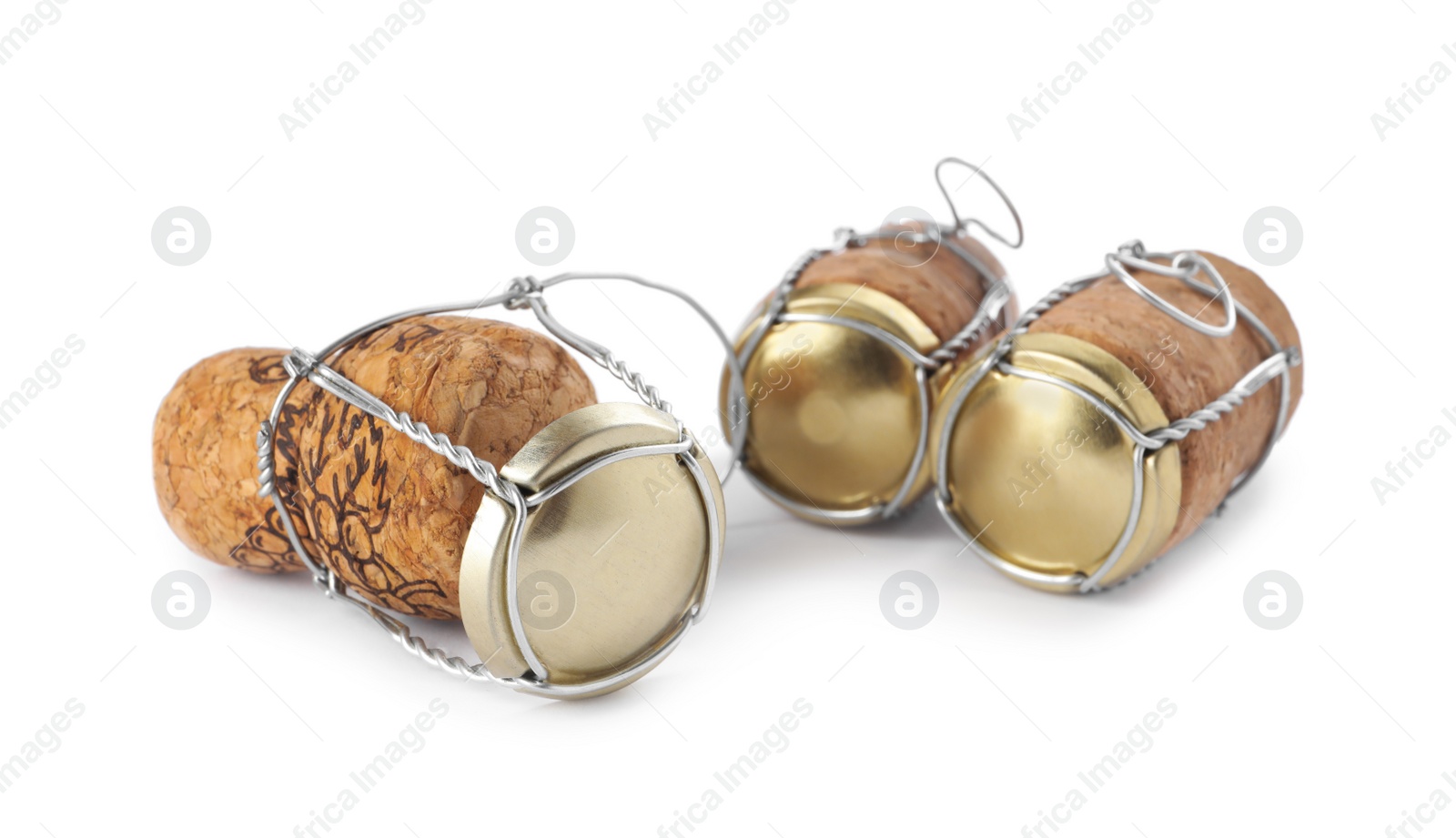 Photo of Corks of sparkling wine and muselet caps on white background