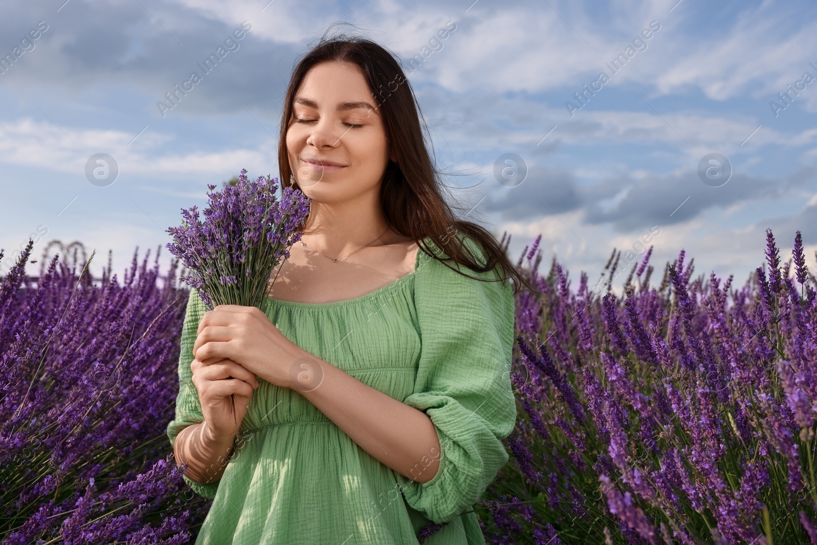 Photo of Beautiful woman with bouquet in lavender field