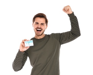 Photo of Happy young man with driving license on white background