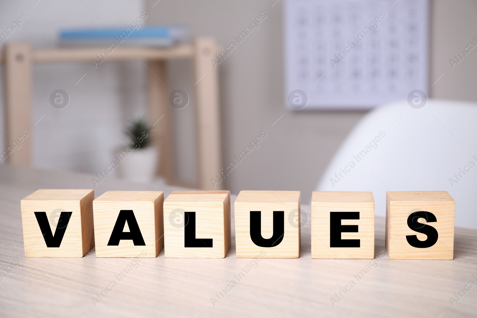 Photo of Cubes with word VALUES on wooden table