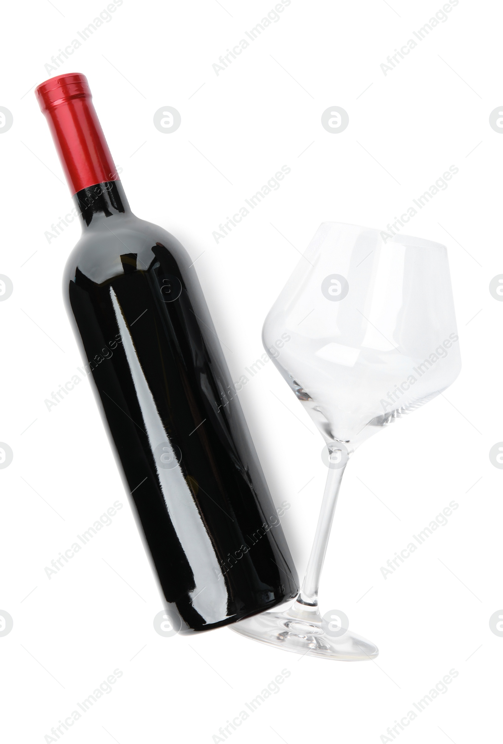 Photo of Bottle of red wine and glass on white background, top view