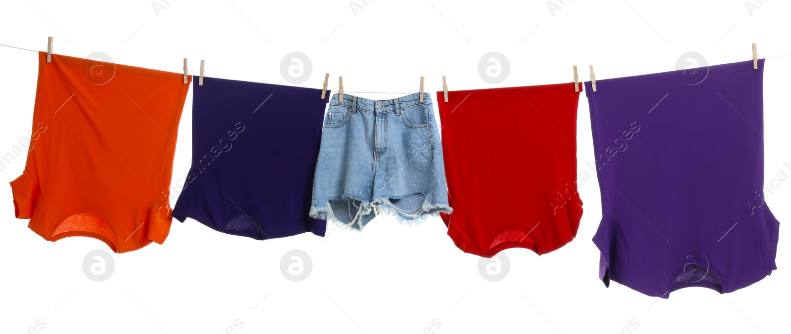 Photo of Different clothes drying on laundry line against white background