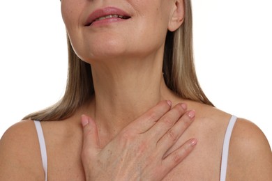 Mature woman touching her neck on white background, closeup