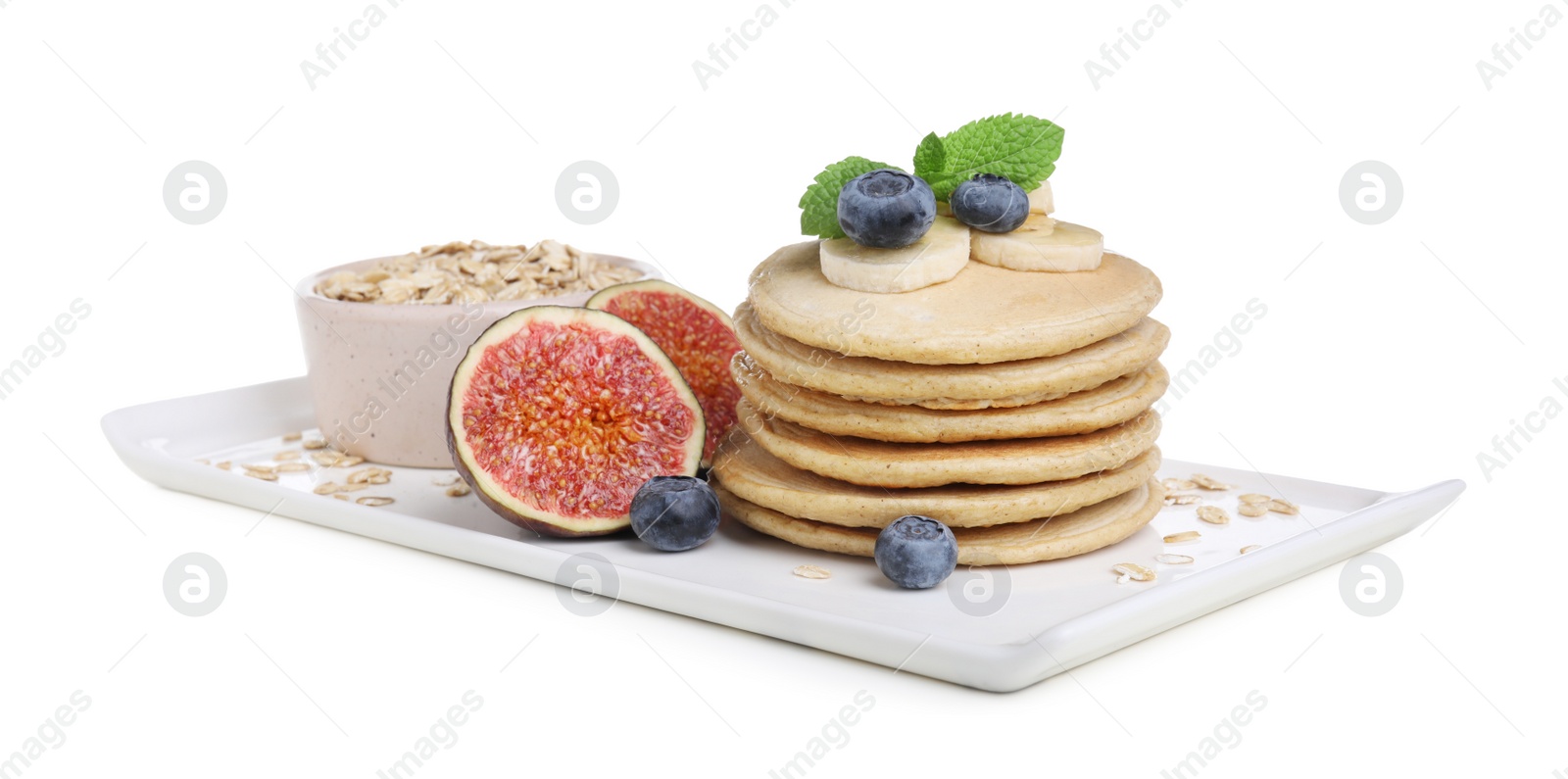 Photo of Tasty oatmeal pancakes and ingredients on white background