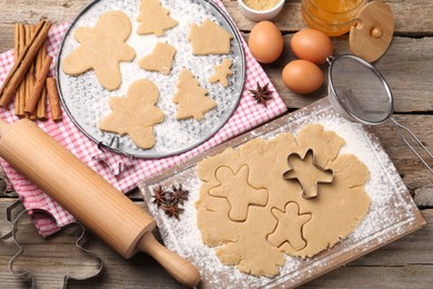 Photo of Making Christmas cookies. Flat lay composition with ingredients and raw dough on wooden table