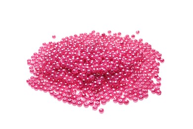 Photo of Pile of pink beads on white background