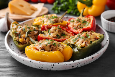 Photo of Tasty stuffed bell peppers on grey wooden table