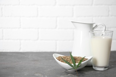 Photo of Composition with hemp milk on grey table