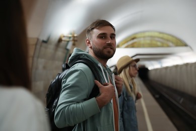 Photo of Young man at subway station. Public transport