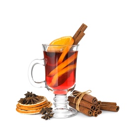Photo of Composition with glass cup of mulled wine, cinnamon and dried orange slices on white background