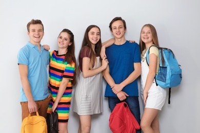 Photo of Group of teenagers on light background. Youth lifestyle and friendship