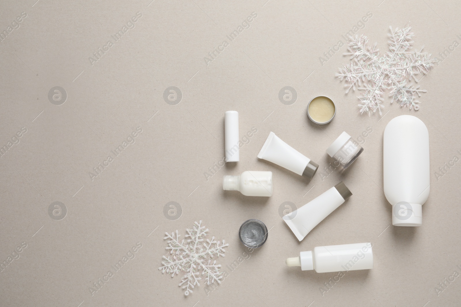 Photo of Set of cosmetic products on gray background, flat lay. Winter care