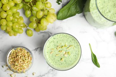 Photo of Flat lay composition with green buckwheat smoothie on white marble table