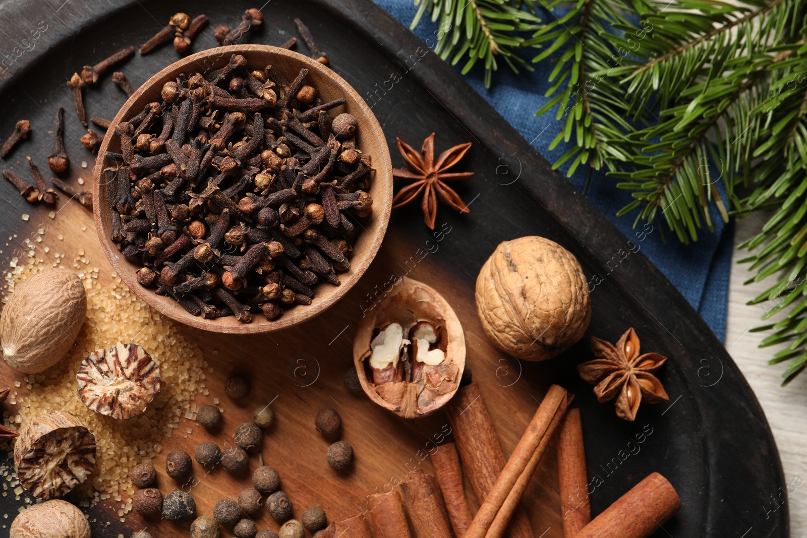 Photo of Different spices and fir branches on table, flat lay