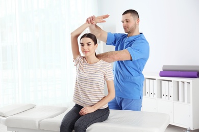 Doctor working with patient in hospital. Rehabilitation physiotherapy