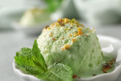 Photo of Delicious pistachio ice cream on table, closeup