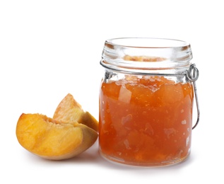 Photo of Jar with peach jam and fresh fruit on white background