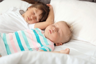 Photo of Little children sleeping in bed at home